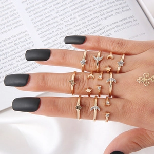 Gedetailleerd overzicht van een bohemien gouden ringenset met maan, ster en glaskralen