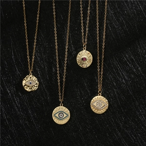 Gold plated evil eye pendant necklaces with sparkling zircon crystals on dark background