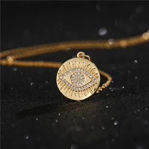 Macro shot of gold-plated evil eye pendant with micro-inlaid cubic zirconia crystals
