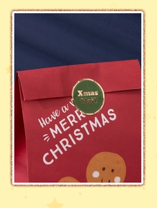 Detail of red Christmas gift paper bag with green Xmas Mail sticker and white lettering