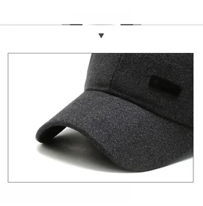 Detail of dark grey wool baseball cap showing firm brim and sport embroidery logo