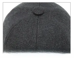 Macro shot of the durable crown suture technique on a dark grey wool baseball cap