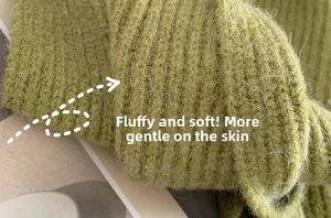 Close-up of grass green ribbed knit scarf showing soft fluffy mohair texture