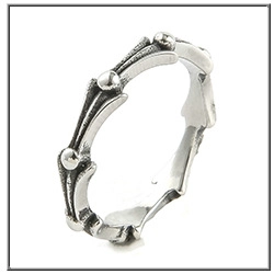 Macro shot of gothic punk silver ring with skeletal spine design and oxidized vintage finish