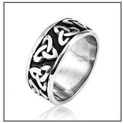 Detail of vintage silver stainless steel men ring featuring black Celtic knot patterns