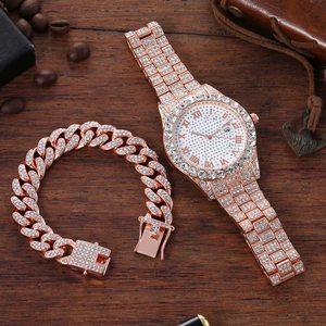 Close-up of rose gold iced-out watch and cuban bracelet set on vintage wood surface