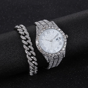 Macro view of iced-out silver watch and Cuban bracelet set with shimmering diamonds