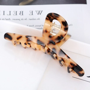 Macro shot of tortoiseshell acetate hair claw clip with leopard pattern and metal spring