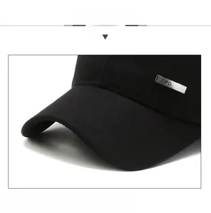 Detailed close-up of a sturdy black baseball cap brim with a Sport metal emblem