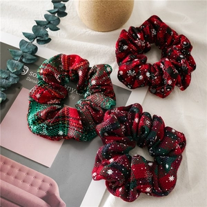Close-up of Christmas scrunchies in red and green plaid and snowflake patterns