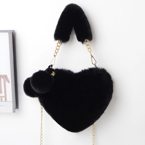 Faux rabbit fur heart-shaped bag in black with gold chain and plush ball charms