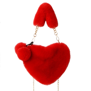 Red heart-shaped faux fur handbag with golden chain handle and soft pompom charms