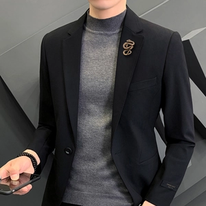Vintage bronze snake brooch with detailed scales on a black blazer lapel for men