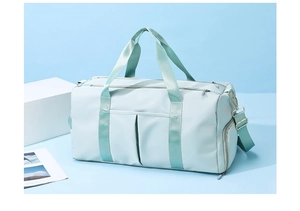 Detail view of mint green gym bag with double front pockets and waterproof nylon texture