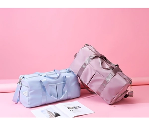 Pastel blue and pink gym bags with dual handles and side zipper compartment detail