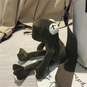Olive green plush frog pendant charm with metal chain on a white canvas tote bag
