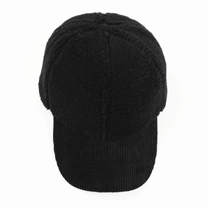 Detail of black baseball cap with lamb wool crown and corduroy brim texture contrast