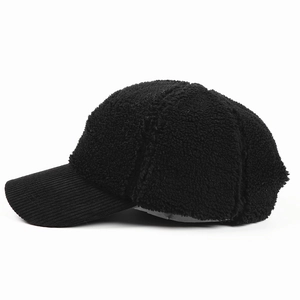 Detail view of the black corduroy brim and soft faux lamb wool crown on this baseball cap