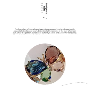 Detailed close-up of crystal butterfly hair clip with multicolored gemstone inlays