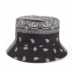 Close-up of black cotton bucket hat with white paisley bandana print and fabric texture