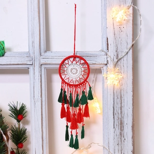 Handmade Christmas dream catcher with red lace frame and festive green tassels