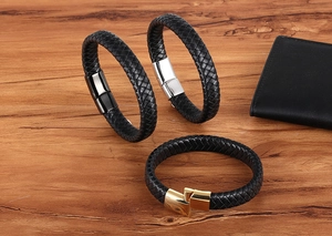Detail of woven black leather bracelets with silver, black, and gold magnetic metal clasps