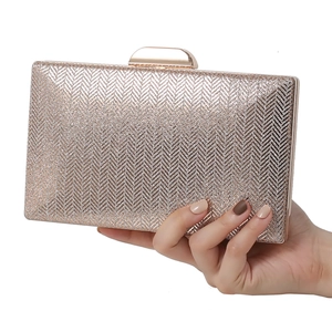 Elegant champagne gold glitter evening clutch bag with metal frame and circular clasp