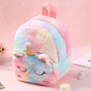Detail of plush unicorn backpack featuring rainbow gradient fur and golden horn