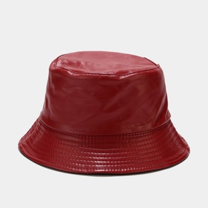 Close-up of red PU leather bucket hat showing textured surface and stitching detail