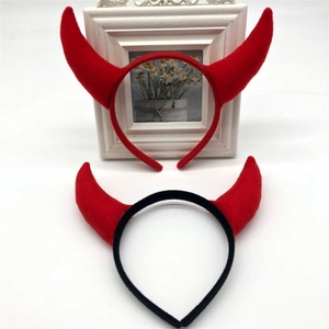 Close-up of red devil horn headbands with plush finish for Halloween party hair styling