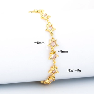 Detailed view of gold star link bracelet with clear zircon insets on a white display