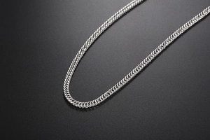 Macro detail of silver titanium steel double xi-link bracelet with high-gloss metallic finish