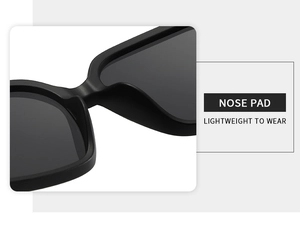 Detail of integrated lightweight nose pads on matte black minimalist sunglasses