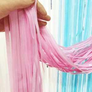 Detailed close-up of pink and blue laser foil fringe curtains for party backdrop decor