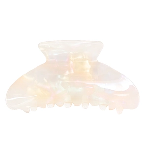 Close-up of iridescent acetate hair claw clip with pearlescent shell finish in white