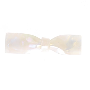 Macro detail of acetate bow hair claw clip with iridescent pearlescent finish