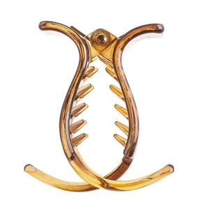 Detailed view of the open teeth structure on a translucent amber resin hair claw clip