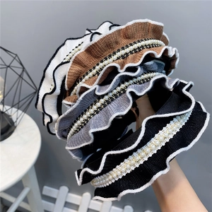Knitted ruffled headbands with elegant pearl embellishments in various classic colors