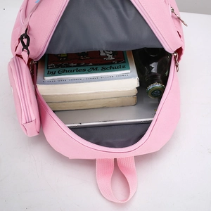 Pink cartoon schoolbag with open main compartment showing books and tablet storage