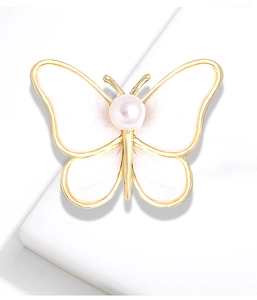 Elegant gold butterfly brooch with pearlescent white wings and central pearl detail
