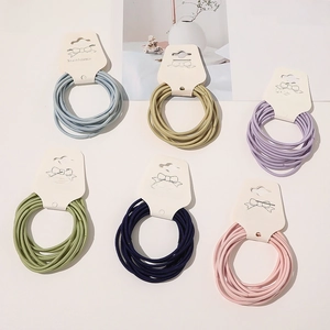 Detailed close-up of colorful high-elastic hair ties set on cards in six pastel shades