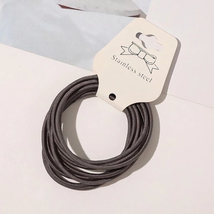 Detail of high-elasticity hair ties set neatly displayed on a branded retail paper card