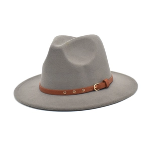 Detail of grey felt wool fedora hat featuring a stylish brown leather decorative belt
