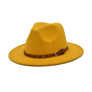 Detailed close-up of yellow felt fedora with brown leather band and metal rivets