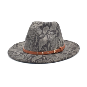 Close-up of grey snakeskin wool fedora with brown studded leather belt buckle strap