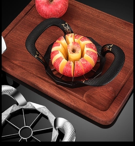 Zinc alloy apple slicer with dual handles cutting a fruit on a wooden board