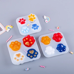 Detail showing cat paw silicone resin molds with colorful finished glitter crafts