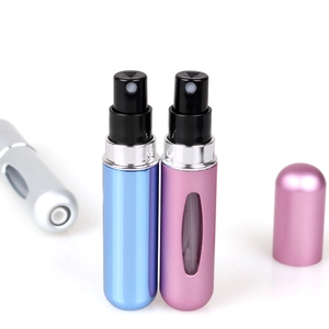 Detail showing pink and blue portable refillable perfume atomizers with metal shells