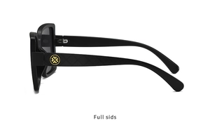 Detail view of black sunglasses with diamond lattice texture and golden circular logo on temples