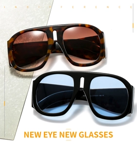 Detail view of oversized sunglasses in tortoise and black frames with color lenses